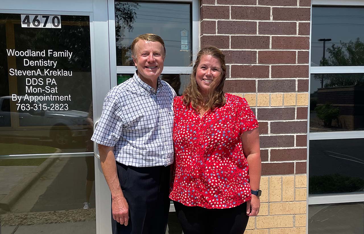 "Woodland Family Dentistry doctors, Dr. Kreklau and Dr. DeWolf Felices, posing outside clinic. Family dentist team."